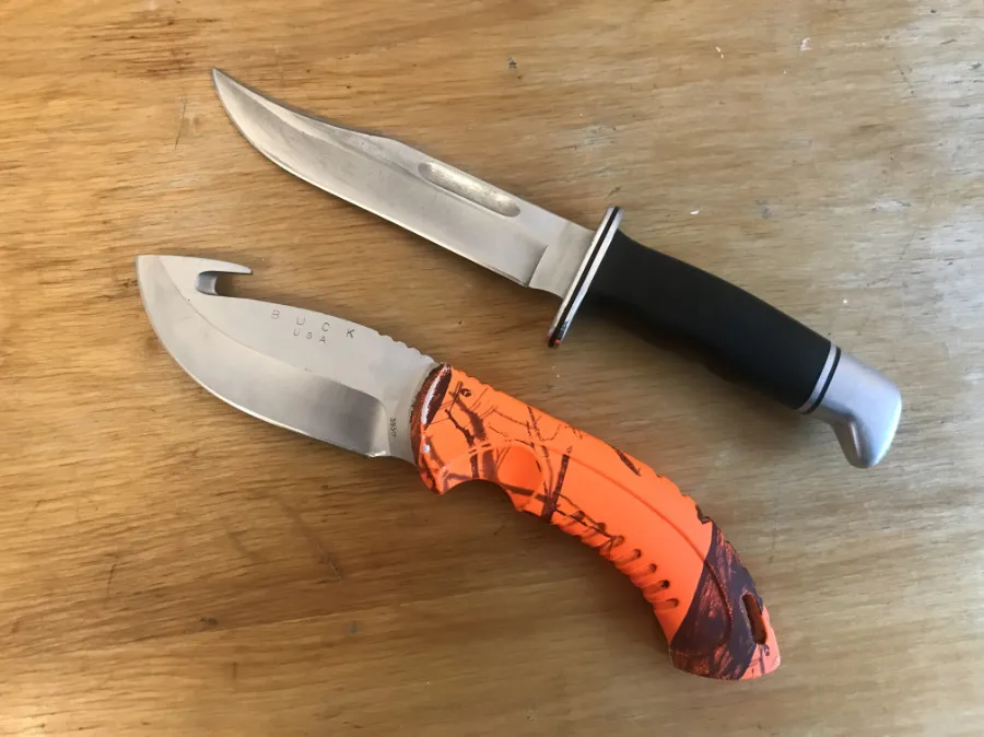 sharpened hunting knives, pocket knives and EDC knives on a wooden background