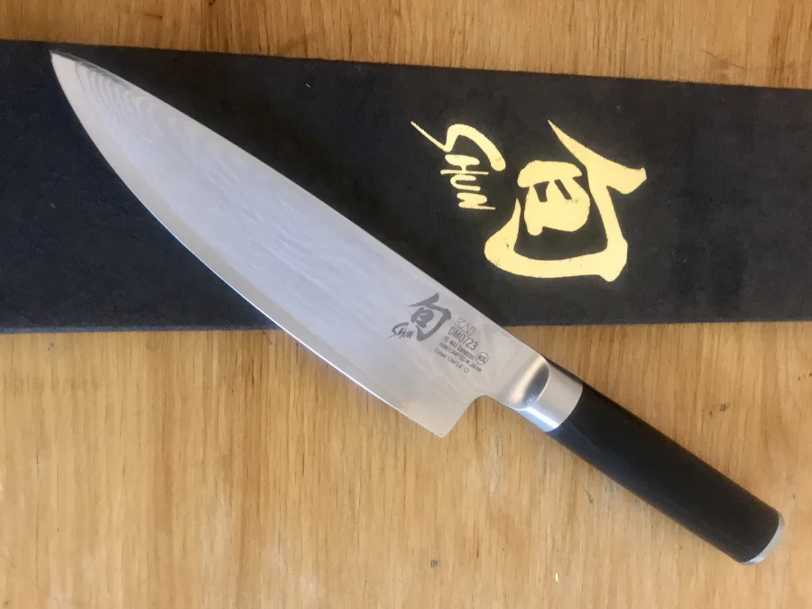 Maritime Sharpening in Halifax sharpens Japanese knives such as this Shun knife lying on its box on a wooden table